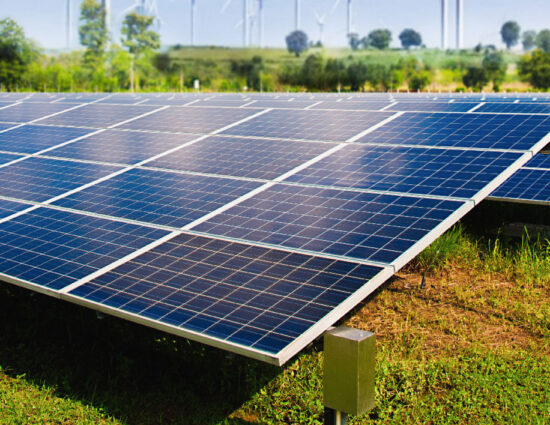 solar-panel-with-wind-turbines-against-mountains-sky